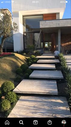 a house with steps leading up to the front door and trees in the back yard