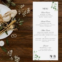 the menu is laid out on a table with flowers and greenery, along with two pairs of scissors