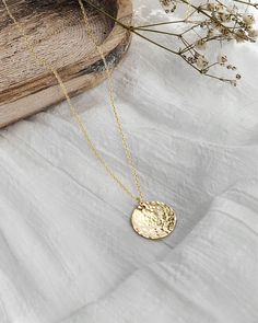 Celebrate your unique journey with a personalized hammered coin necklace. The 3/4'' coin is our favorite size! It provides generous space for a meaningful, extended message. Engrave a phrase that inspires and supports you through every step of your growth and healing. This hand-hammered charm is a daily reminder to honor your true self, embracing both your strengths and imperfections. Made with premium 14k gold-filled or .925 sterling siver, this necklace is designed for durability and beauty. P Hammered Yellow Gold Medallion Necklace As A Gift, Hammered Yellow Gold Medallion Necklace Gift, Hammered Round Medallion Necklace As Gift, Everyday Hammered Coin Necklace With Round Pendant, Hammered Coin Necklace As Gift, Hammered Round Disc Coin Necklace As Gift, Hammered Medallion Coin Necklace As Gift, Hammered Coin Necklace Gift, Hammered Medallion Coin Necklace Gift