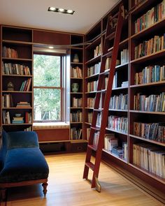 a ladder leaning up against a bookshelf in a room filled with lots of books