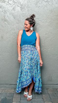 Show up to your next event feeling bold and confident in our Jasmine Boho Skirt! This beautiful skirt is perfect for date nights, beach vacations, or just running errands! With a vibrant blue floral paisley print with mint background and hints of purple, this maxi skirt will have you standing out from the crowd and feeing sexy! The flattering waistband and flowy fit will make you feel comfortable and stylish! You can easily pair this skirt with our Jasmine Boho Crop Top or a simple light blue sh Blue Flowy Floral Print Bottoms, Flowy Blue Skirt For The Beach, Casual Paisley Print Skirt For Vacation, Blue Floral Print Maxi Skirt For The Beach, Summer Beach Printed Maxi Skirt, Blue Boho Print Maxi Skirt For Vacation, Spring Paisley Print Flowy Maxi Skirt, Spring Flowy Maxi Skirt With Paisley Print, Summer Paisley Print Long Skirt