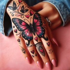 a woman's hand with tattoos and hearts on it