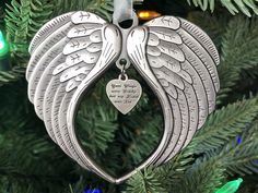 an angel ornament hanging from a christmas tree