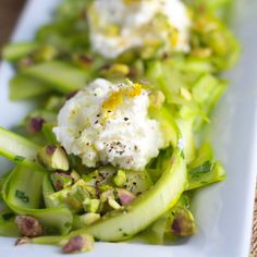 a white plate topped with celery and whipped cream