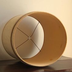 a lamp shade sitting on top of a wooden table