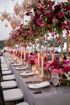 a long table with flowers and candles is set up for a formal dinner or reception