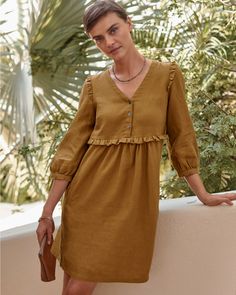 A summery statement of feminine style in soft linen, with well-placed ruffles at the shoulders and waist, flattering gathers, and blouson-style sleeves — plus pockets. Wear this pullover dress casual or dressy, for daytime or date night.  Exclusive. V-neckline with three-button placket. 3/4 sleeves with gathered, buttoned cuffs. Empire waist with gathers in front and back. Welt hand pockets. Well Dress Women, Botton Dresses, Empire Waist Dress Casual, Fashion Over Fifty, Flamboyant Gamine, Empire Waist Dress, Garnet Hill, Linen Dresses, Knit Skirt