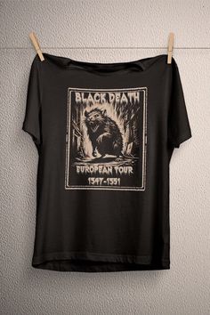 a black t - shirt hanging on a clothes line with an image of a porcupine