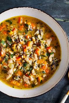 a white bowl filled with chicken and vegetable soup