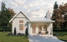 a small white house sitting on top of a lush green field