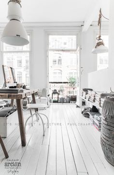 a room with white walls and wooden floors