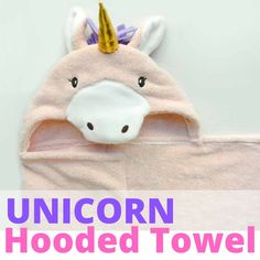 the unicorn hooded towel is pink and has a gold horn on it