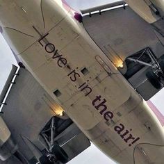 an airplane with the words love is in the air written on it