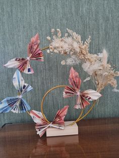 an arrangement of paper flowers on a wooden table