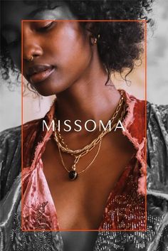 a woman wearing a necklace with the word missoma on it