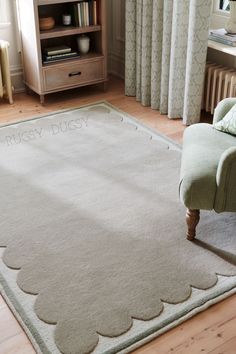 a living room with a chair and rug on the floor