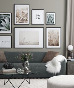 a living room filled with lots of pictures on the wall above a glass coffee table