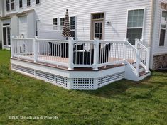 a white deck in front of a house