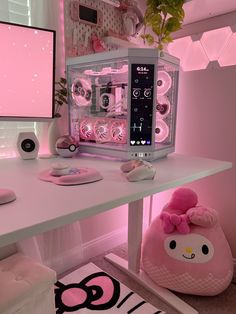 a desktop computer sitting on top of a desk next to a pink hello kitty bag