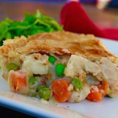 a piece of chicken pot pie sitting on top of a white plate