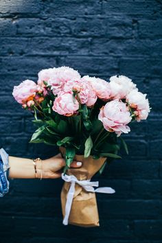 a person holding a bouquet of flowers with the words best floral gifts unique gift inspiration