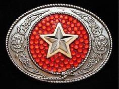 a red and silver belt buckle with a star in the center on a black background