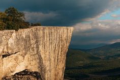 a person standing on the edge of a cliff