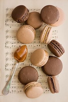 some macaroons are sitting on top of sheet music