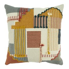 an orange and brown pillow with different colored squares on the front, one is made out of