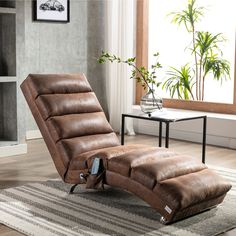 a recliner chair sitting on top of a rug next to a table and potted plant