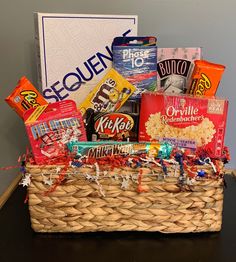 a basket filled with candy and snacks on top of a table