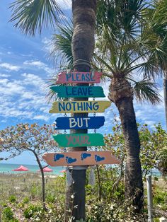 a sign that is on the side of a palm tree