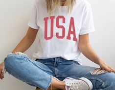 Show your patriotic spirit in style with our USA graphic t-shirt. Whether you're at the parade or hanging out with friends, you can rock your American pride with this fashionable tee. We're gonna make you an offer you can't refuse: the best 100% cotton tee you've ever tried. Pre-shrunk fabric? Check. Side-seamed construction? Check. Best fit ever? Double check. * 100% combed and ring-spun cotton (Heather colors contain polyester) * Fabric weight: 4.2 oz/yd² (142 g/m²) * Pre-shrunk fabric * Side- 4th Of July Relaxed Fit T-shirt With Text Print, 4th Of July Relaxed Fit Screen Print T-shirt, Relaxed Fit Screen Print T-shirt For 4th Of July, 4th Of July Streetwear T-shirt With Letter Print, 4th Of July Relaxed Fit T-shirt Made In Usa, Patriotic Letter Print T-shirt For 4th Of July, Patriotic 4th Of July T-shirt With Letter Print, American Flag Print Patriotic Tops, Screen Print Tops For 4th Of July Streetwear