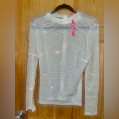 Sheer Beaded Long Sleeved Top White Top With Rhinestones For Night Out, Fitted Beaded Tops For Spring, Fitted Long Sleeve Blouse With Rhinestones, Glamorous White Tops With Rhinestones, Rhinestone Blouse For Spring, Glamorous Embellished Top For Winter, Chic Embellished Stretch Tops, Chic Stretch Embellished Tops, Spring Stretch Tops With Rhinestones