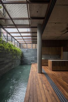 an indoor swimming pool with wooden floors and walls