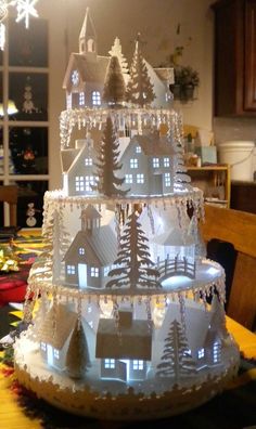 a christmas tree made out of ice and snowflakes on a table in front of a window