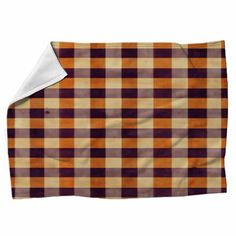 an orange and brown checkered blanket with white border