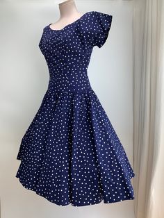 1950's Navy Blue & White Polka-Dot Drop-Waist Dress. Quality cotton fabric with a fitted bodice and a drop waist, a full gathered skirt, and a scoop neckline.  There is a metal side zipper that works great.  This garment is in EXCELLENT VINTAGE CONDITION... no issues to note. There are no stains, holes, repairs or snags. The label reads: R & K ORIGINAL personally yours **I would say that this dress is a  WOMEN'S SIZE SMALL to MEDIUM with a 27 inch waist ( I have shown this dress with a petticoat Fitted 1950s Style Polka Dot Dress, Fitted Polka Dot Dress In 1950s Style, Fitted Rockabilly Dresses For Vintage Fashion, Fitted Retro Polka Dot Vintage Dress, Fitted Full Skirt Vintage Dress For Vintage Fashion, Retro Fitted Polka Dot Vintage Dress, Fitted Short Sleeve Rockabilly Vintage Dress, Fitted Retro Vintage Dress Knee-length, Fitted Cotton Vintage Dress, Tea Length