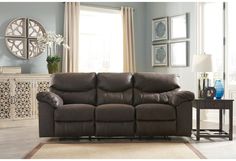 a living room scene with focus on the reclining sofa