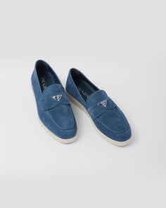 Band with enameled triangle logo Apron with pinched stitch seam Light rubber sole Heel height: 15 mm Removable leather-covered insole Blue Slip-on Loafers With Contrast Sole, Blue Loafers With Contrast Sole Slip-on, Modern Blue Loafers With Textured Sole, Classic Blue Moccasins With Leather Sole, Classic Blue Moccasins With Stitched Sole, Blue Leather Low-top Boat Shoes, Blue Low-top Leather Boat Shoes, Blue Leather Low-top Moccasins, Blue Leather Low-top Loafers