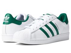 adidas Originals Superstar - Men's Classic Shoes : White/Collegiate Green/White : Get with the timeless looks of the Superstar from adidas Originals. Leather and synthetic uppers with the classic 3-Stripes design. Lightly padded tongue and collar for added comfort. Lace-up closure for an adjustable fit. Signature rubber shell toe bumper. Breathable textile lining and a padded footbed for added comfort. Lightly cushioned footbed for added support. Rubber outsole with herringbone tread for tractio Classic Sneakers With Three Stripes Branding And Round Toe, Classic Sneakers With Three Stripes And Round Toe, Synthetic Lace-up Skate Shoes With Three Stripes, High-top Synthetic Skate Shoes With Three Stripes, Classic High-top Skate Shoes With Three Stripes Branding, Classic High-top Skate Shoes With Three Stripes, Classic Sneakers With Three Stripes For Streetwear, Classic Three Stripes Sneakers For Streetwear, Leather Lace-up Skate Shoes With Three Stripes