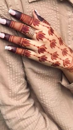 a woman's hand with henna on it