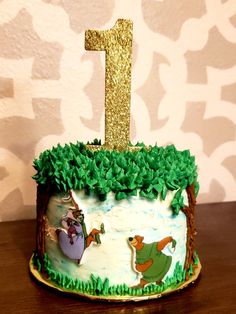 the first birthday cake for winnie the pooh is decorated with green grass and gold glitter