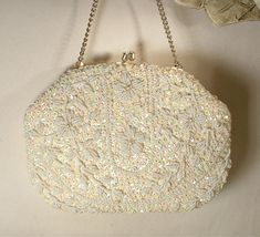 I am SO happy to be offering this beyond beautiful vintage collectible high-end designer "Richere" Art Deco hand beaded warm ivory pearl and sequins and white bead gold flapper purse  perfect for the Bride. I can't tell you how much I adore the design of this purse!  This bag is in near PRISTINE vintage condition. If you've ever seen one of these Richere purses in person you know that photos are not doing it justice or capturing the attention to detail adequately.  It is completely covered with Vintage Evening Bag With Handwork For Formal Occasions, Vintage Handwork Evening Bag For Party, Vintage Handwork Evening Bag For Wedding, Vintage Wedding Evening Bag With Handwork, Vintage White Embellished Bags, Victorian Clutch Bag For Wedding, Embellished Cream Evening Bag For Wedding, Vintage White Party Bags, White Vintage Party Bag