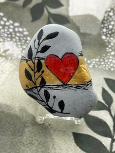 a painted rock with a heart on it