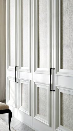 the interior of a bedroom with white closet doors and black handle handles on each door