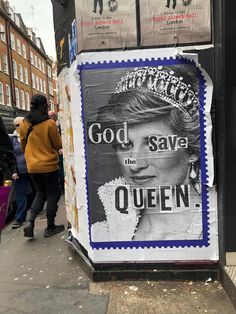 a poster on the side of a building advertising queen elizabeth, god save the queen