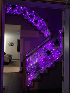 the stairs are decorated with purple lights and spider decorations