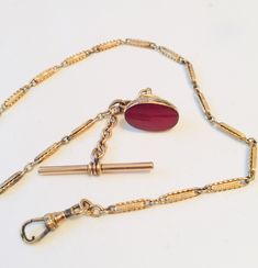 Victorian Watch Chain Goldfilled w 9K Gold Carnelian Seal Fob, TBar, Swivel, Hallmarks 375 Gold Fill Watch Chain with a 9 K Gold Seal Fob, unmarked. 2 Hallmarks on the seal Fob, including 375 and an anchor. Another hallmark on the ring near the swivel. In very good antique condition. A particularly lovely seal.  14 1/2 inches long. Fob Chain Necklace, Antique Formal Jewelry With Gold Clasp, Antique Chain Jewelry For Formal Occasions, Antique Formal Jewelry Chain, Heirloom Link Jewelry For Formal Occasions, Antique Style Formal Jewelry Chain, Formal Antique Jewelry With Chain Details, Antique Jewelry With Polished Oval Link Finish, Antique Oval Link Jewelry With Polished Finish