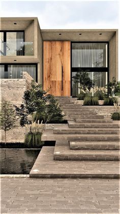 the stairs lead up to the front door of this modern house